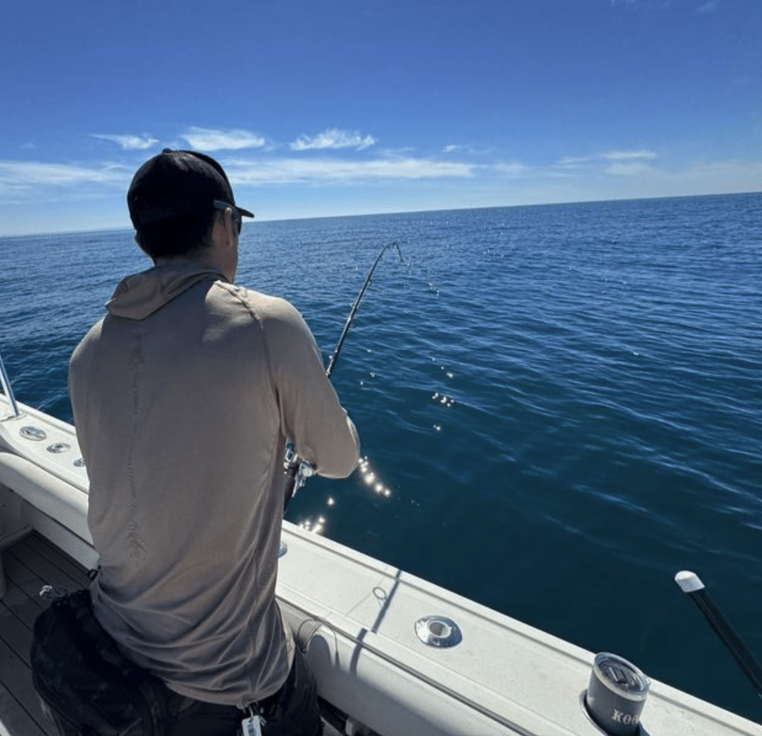 Angler reeling in san diego waters with plentiful fishing spot taken by Coast To Coast Sport Fishing before el nino san diego fishing season